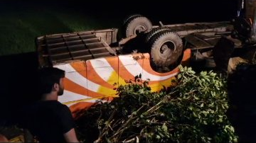 At least four people from Uttar Pradesh lost their lives when a bus carrying 57 tourists overturned on National Highway 16 in Balasore district late last night.