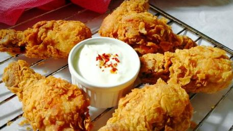 Creating a homemade KFC-style chicken bucket involves marinating the chicken in a flavorful blend of herbs and spices, followed by a double coating of seasoned flour for that crispy texture