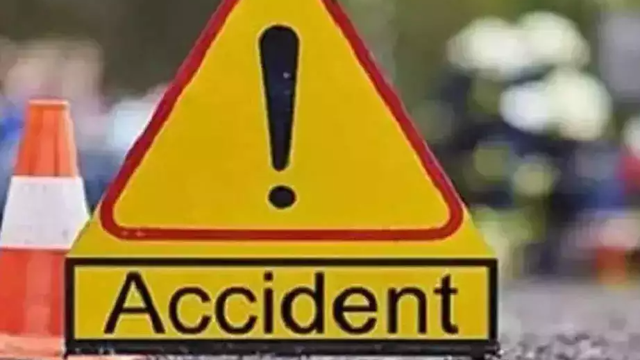 At least two persons died and three others were injured after a car in which they were travelling hit a stationary truck on Thursday morning