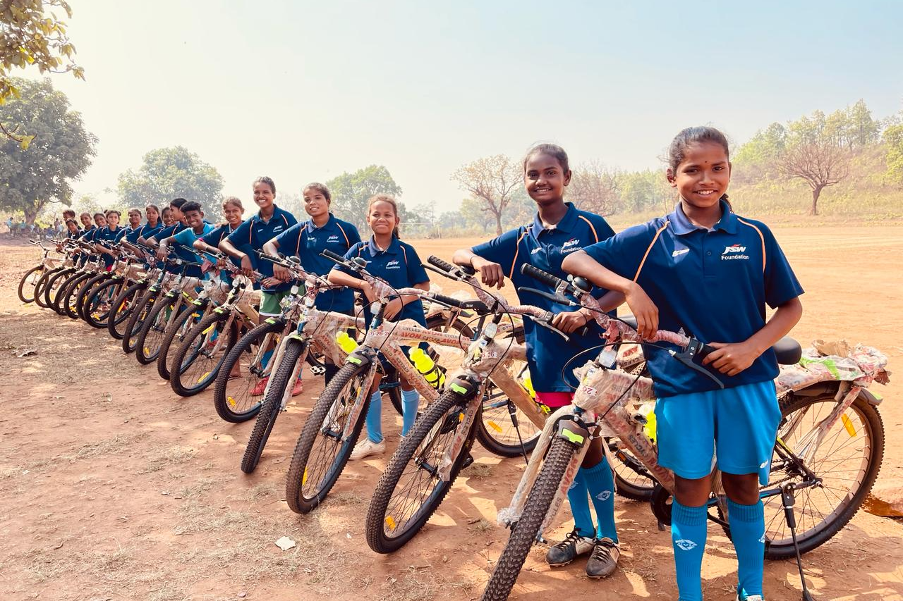 JSW distributes bi-cycles to young footballers