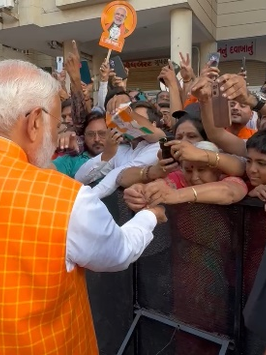 Woman ties rakhi to PM Modi near polling booth in Ahmedabad