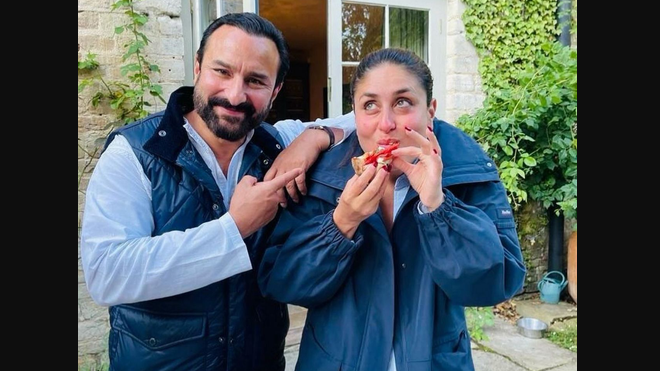 Saif is donning a white kurta pyajama, and a sleevless jacket. While, Kareena is wearing a white shirt and paired it with a blue full sleeves jacket. She has kept her hair tied in a bun, and is seen enjoying a pizza slice