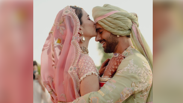 In the pictures, Kriti can be seen wearing a pastel pink lehenga, while Pulkit can be seen dressed in a pastel green outfit.  In one of the pictures, Kriti can be seen planting a kiss on her husband's forehead