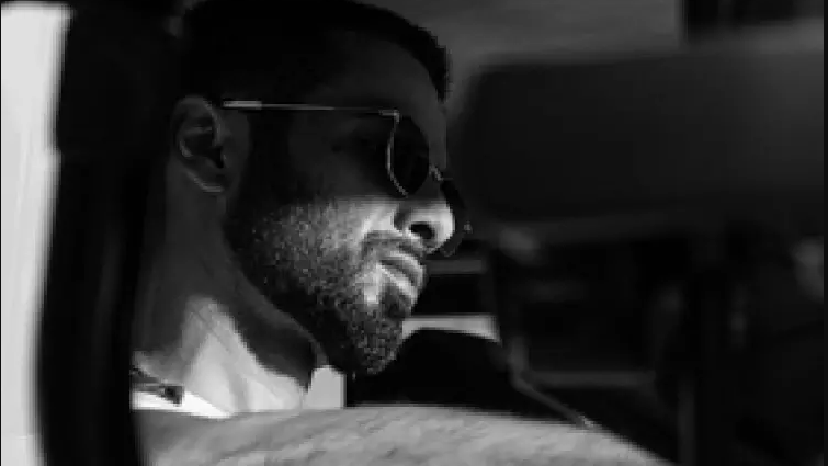 In the black and white snap, we can see Shahid looking away from the camera, while he is sitting in a car. He is sporting sunglasses